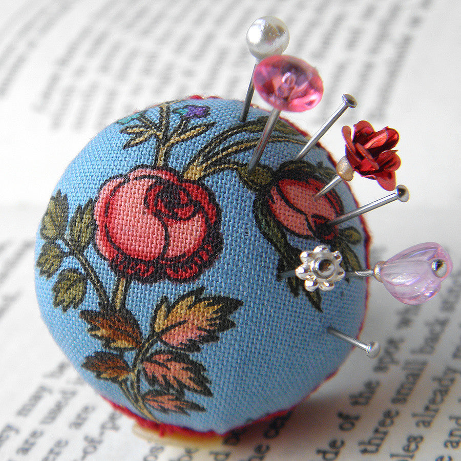 Handmade wearable pincusion ring in blue and red roses design