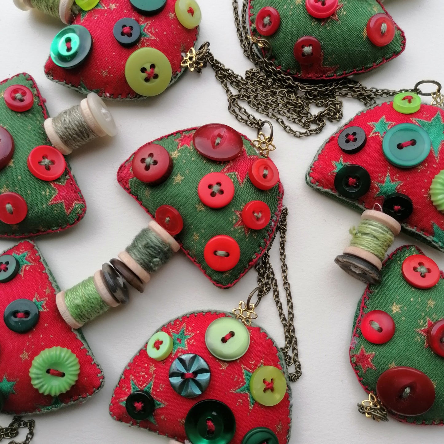 Red and Green fabric toadstool ornaments with buttons and spools.