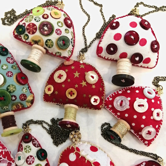 Collection of fabric toadstool ornaments with buttons and spools